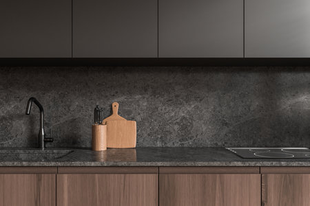 Dark and wooden home kitchen interior with sink and electric stove, empty quartz counter. Closeup of elegant cooking area in luxury apartment. 3D renderingの写真素材