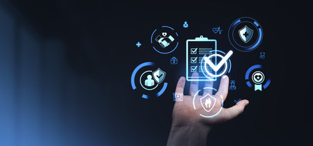 Digital health and insurance icons displayed on an open hand against a dark background, symbolizing coverage and benefitsの写真素材