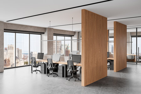 Spacious modern coworking office with wooden dividers, desks, and chairs. Large windows with city view, concrete floor, open space concept. 3D Renderingの写真素材