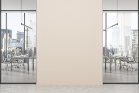 Cozy office interior with pc computers on desks in row, concrete floor. Glass coworking room with panoramic window on New York skyscrapers. Mock up empty wall. 3D renderingの写真素材