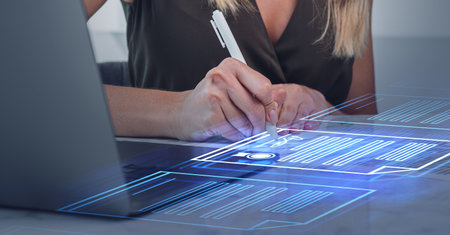 A woman signs a digital contract using a stylus pen, on a holographic interface. Business setting. Concept of secure online document signingの写真素材