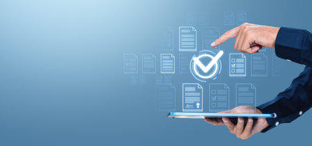 Man finger touch glowing check mark using tablet, virtual screen with digital document system hologram files or certifications. Concept of approval and online evaluation. Copy spaceの写真素材