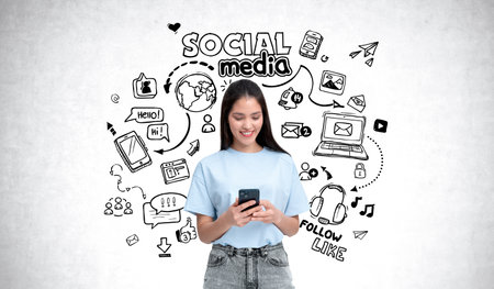 Woman using phone, surrounded by illustrated social media icons, on a white wall background. Concept of digital communicationの写真素材