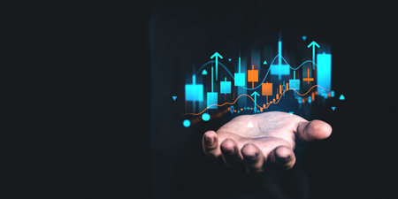 A hand holding a financial chart with rising arrows on a dark background, symbolizing growth and success in business conceptsの写真素材