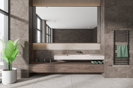 Modern bathroom with large mirror, wood vanity, and towel hanger. Stone walls, large windows, and indoor plant. Minimalist design. 3D Renderingの写真素材