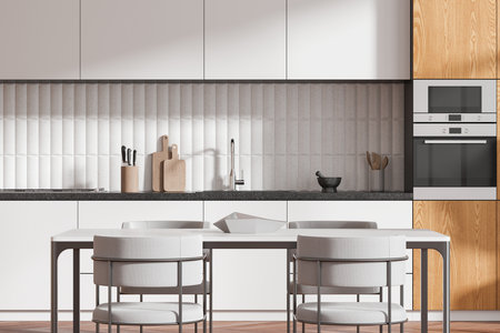 White and wooden home kitchen interior eating table and chairs, cooking cabinet with kitchenware and sink. Dining zone in modern apartment. 3D renderingの写真素材