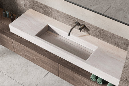 Modern minimalist bathroom sink and faucet in a wooden vanity unit, set against a light stone wall and floor. Concept of interior design. 3D Renderingの写真素材