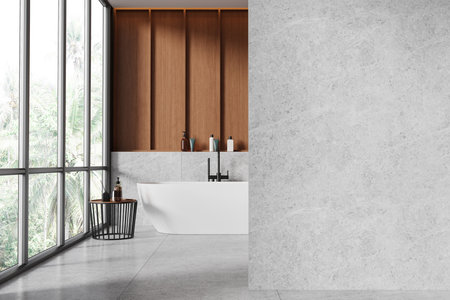Wooden and tile hotel bathroom interior with white bathtub, side table with accessories. Bathing space in modern apartment with panoramic window. Empty wall partition. 3D renderingの写真素材