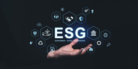 Hand holding glowing ESG icons, symbolizing environment, social, and governance concepts. Dark background emphasizes sustainability focusの写真素材