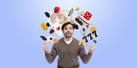 A joyful man celebrates while surrounded by casino symbols like dice, chips, and cards on a blue background, capturing the excitement of gamblingの写真素材