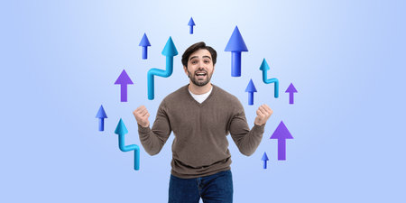 Excited happy man holding fists, looking at the camera. Colorful rising arrow lines on blue background. Concept of business achievement, win, luck and successの写真素材