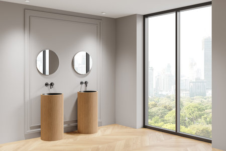 Minimalist bathroom with dual wooden sinks, round mirrors, large window showing cityscape, neutral tones. Stylish interior design. 3D Renderingの写真素材