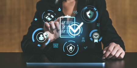 Person interacting with digital health and insurance icons on tablet screen, holographic style, modern business setting, concept of innovationの写真素材