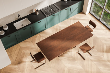 Top view of home kitchen interior with green and white cooking cabinet, wooden dinner table and chairs on hardwood floor. Eating space with panoramic window on tropics. 3D renderingの写真素材