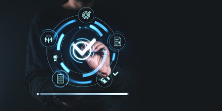 Person interacting with holographic interface, highlighting a digital checkbox on dark background. Concept of project approval and qualityの写真素材