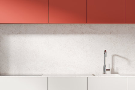 Modern kitchen with red cabinets and sleek sink on a light stone background. Concept of contemporary home design. 3D Renderingの写真素材