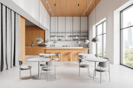Sleek cafe interior with minimalist tables and chairs, wooden accents, large windows, and contemporary lighting. 3D Renderingの写真素材
