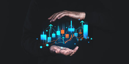 Hands surround a glowing digital financial chart with arrows pointing up, on a dark background, symbolizing market growthの写真素材