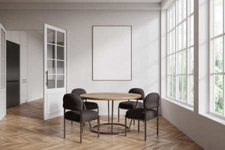 Blank poster mockup hanging on a neutral-colored wall in a dining room with wooden flooring, large windows, and modern chairs. 3D Renderingの写真素材
