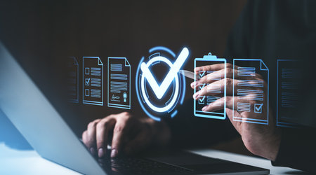 Hands using a laptop with holographic documents and checkmarks, symbolizing approval on a dark background, concept of digital approvalの写真素材