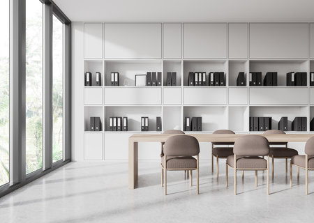 Spacious meeting room with a long wooden table and chairs, set against shelves filled with binders. Bright, airy interior design. 3D Renderingの写真素材