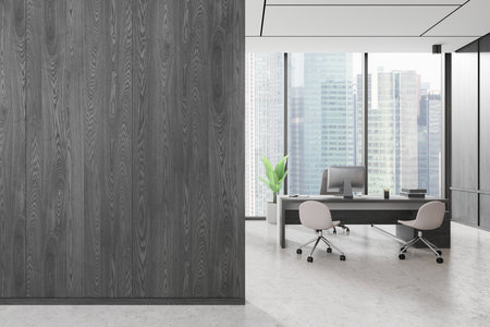 Contemporary office interior with a minimalist desk and chairs setup, large windows showing city buildings behind, wood-panel wall on the left, modern office concept. 3D Rendering.の写真素材