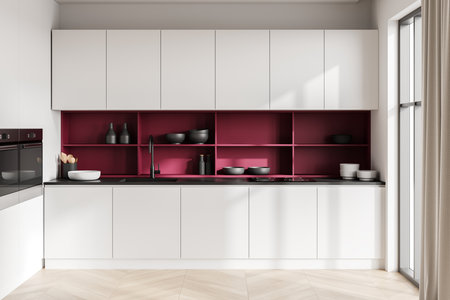 A modern white kitchen with pink shelving, sleek cabinets, and countertop. Light from large windows. Minimalist kitchen interior style. 3D Rendering.の写真素材