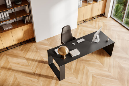 An elegant modern office interior featuring a sleek black desk, chair, and wooden shelves on a parquet floor, with natural light from large windows. 3D Renderingの写真素材