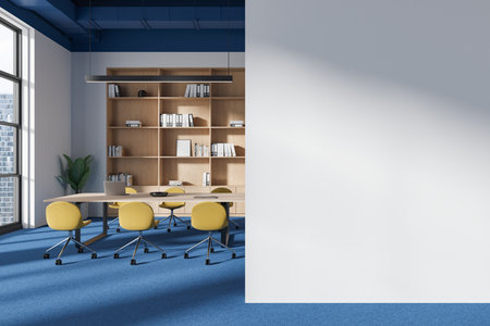 A blank white wall mockup in a modern office with wooden shelves, yellow chairs, and blue carpet. Concept of workspace design. 3D Renderingの写真素材