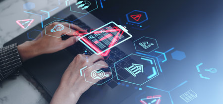 Hands typing on a laptop with holographic risk management and safety icons. Blue and red glowing digital interface. Concept of business and securityの写真素材
