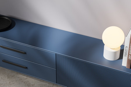 A sleek blue countertop with a round glowing lamp, books, and minimal decor. Modern and clean design concept on a neutral background. 3D Renderingの写真素材