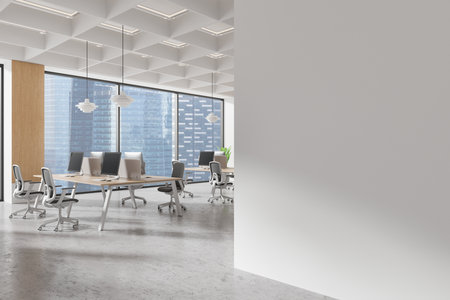 An empty blank wall mockup in a bright office setting featuring desks, chairs, and large windows with cityscape views. 3D Renderingの写真素材