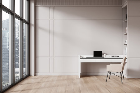 Minimalist home office with a desk, chair, and laptop. Modern interior design with large windows offering city views. Light wooden floor, bright atmosphere. 3D Rendering.の写真素材