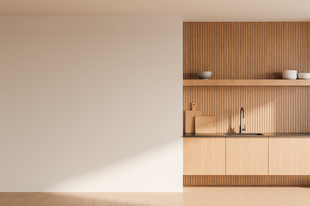 Minimalist kitchen with an empty white wall and wooden cabinets. Light wooden textures with decor on the countertop. Blank wall for copy space. 3D Renderingの写真素材