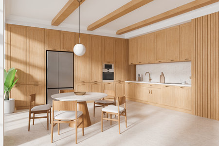 A modern kitchen with wooden cabinets, a round dining table, chairs, and ceiling beams. Bright lighting, light-colored floor, and plant in corner. 3D Renderingの写真素材