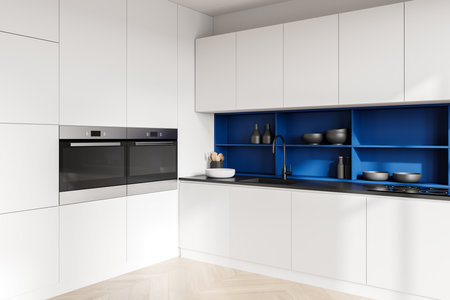 Modern kitchen interior featuring sleek white cabinets, a vibrant blue shelf, built-in appliances, and a wooden floor. Concept of home cooking space. 3D Rendering.の写真素材