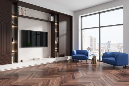 A modern living room featuring blue armchairs, built-in shelves, and a large window with a city view. Wooden herringbone floors. Interior design concept. 3D Renderingの写真素材