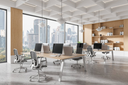 Spacious modern office interior with sleek workstations, chairs, and computers. Large windows show a cityscape. Clean, minimalistic design concept. 3D Renderingの写真素材