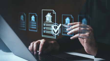 Hands interacting with holographic real estate documents, checklist icons, and a laptop. Dark background. Concept of digital property managementの写真素材