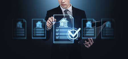 A businessman using a futuristic digital interface to interact with real estate documents, wearing a suit, on a dark background, concept of technology in real estateの写真素材