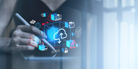 Hand holding a stylus interacting with glowing cloud storage, network, and cybersecurity icons on a blurred background. Concept of secure online dataの写真素材