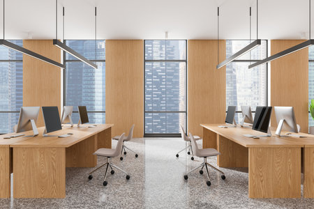 Modern office interior with wooden desks, chairs, and computers, featuring large windows with a city view. Bright and minimalistic workspace concept. 3D Rendering.の写真素材