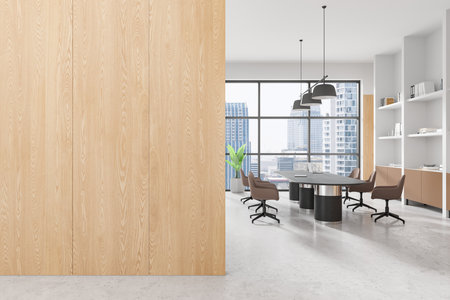 Office interior with wooden wall, large windows revealing a cityscape, modern furniture on gray flooring, concept of coworking or business space. 3D Rendering.の写真素材