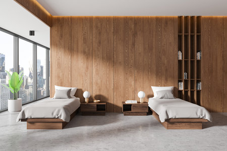 Stylish twin bedroom with wooden paneling, minimalist furniture, large windows showcasing cityscape, and warm lighting. Concept of modern interior. 3D Rendering.の写真素材