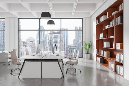 Office space with white desks, beige chairs, computers, red bookshelf, and large windows. Bright, clean, urban interior concept. 3D Renderingの写真素材