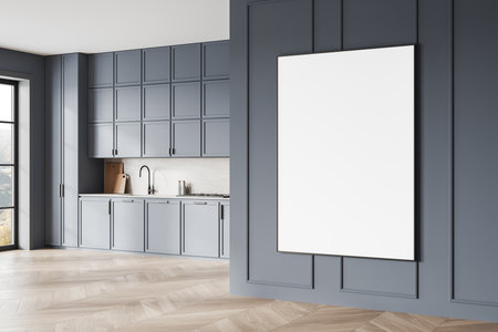 Stylish kitchen with blue cabinets, wooden floor, and blank white canvas on a paneled wall. Bright natural light, minimalist concept. 3D Rendering.の写真素材