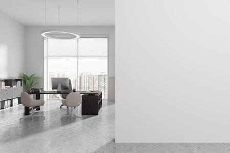 Modern office space with desk, chairs, and large window. Blank white wall on the right side. Concrete floor. Perfect for displaying a mockup or design template. 3D Rendering.の写真素材