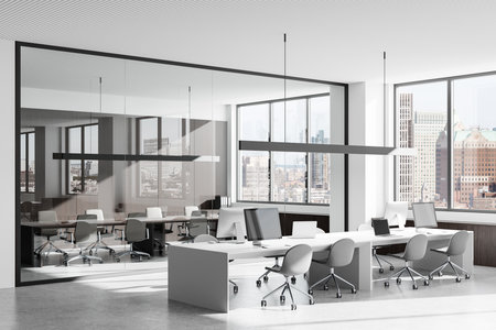 Open modern office with desks, chairs, computers, glass partitions, large windows, and a bright cityscape view. Concept of coworking space. 3D Rendering.の写真素材