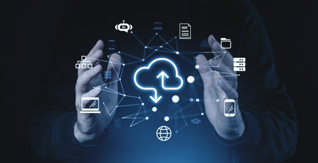 Hands surrounding glowing cloud icons with data, storage, and network symbols. Dark background highlights the concept of online cloud technologyの写真素材