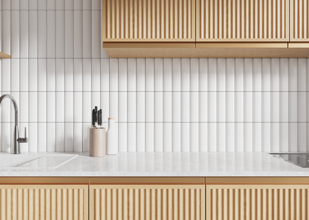 Modern kitchen showcasing light wood cabinets, white textured tiled backsplash, and minimalist accents on a clean countertop. Contemporary design. 3D Rendering.の写真素材
